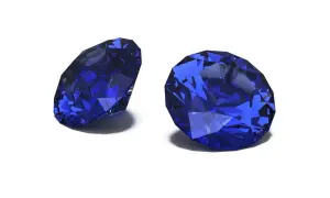 Zwei facettierte Saphire in tiefem Blau, die ihre Brillanz zeigen. Der Saphir steht für Weisheit und Treue.