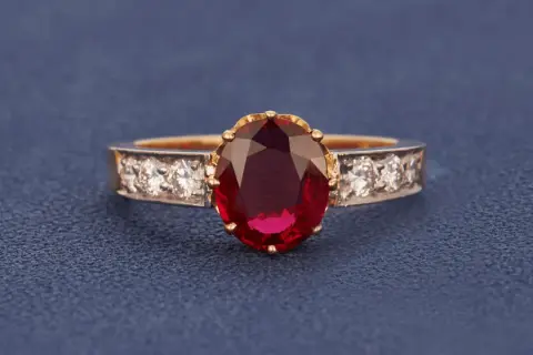 Ein Ring mit einem ovalen, tiefroten Edelstein, der an einen Rubin erinnert. Der Unterschied zwischen Granat und Rubin ist oft die Farbe.
