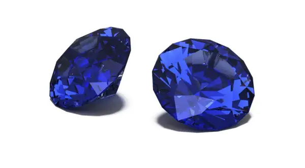 Zwei facettierte Saphire in tiefem Blau, die ihre Brillanz zeigen. Der Saphir steht für Weisheit und Treue.