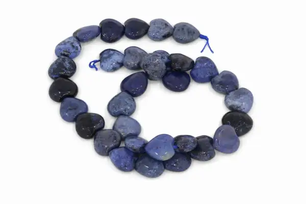 Herzförmige Perlen aus blauem Dumortierit, auf einer Schnur aufgereiht, mit dunklen und hellen Mustern.